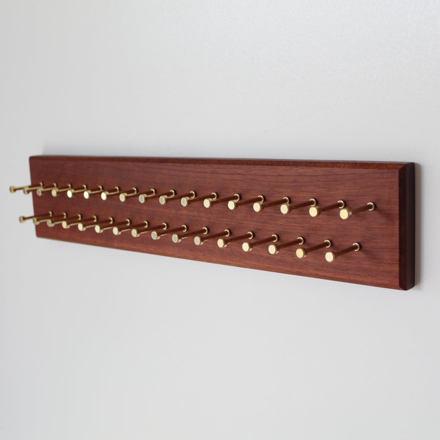 Custom bubinga tie rack with brass pegs